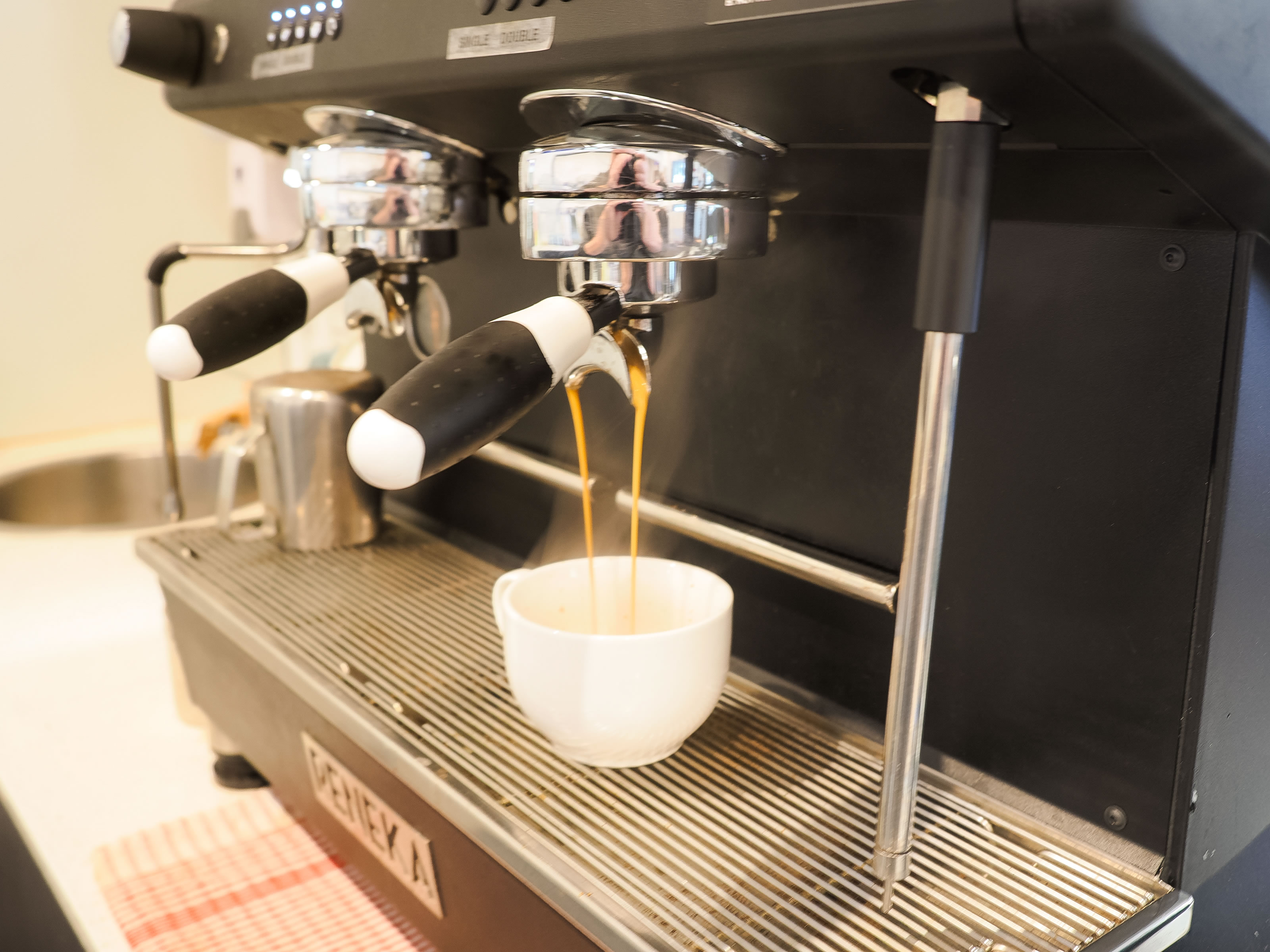 Espresso pouring from coffee machine