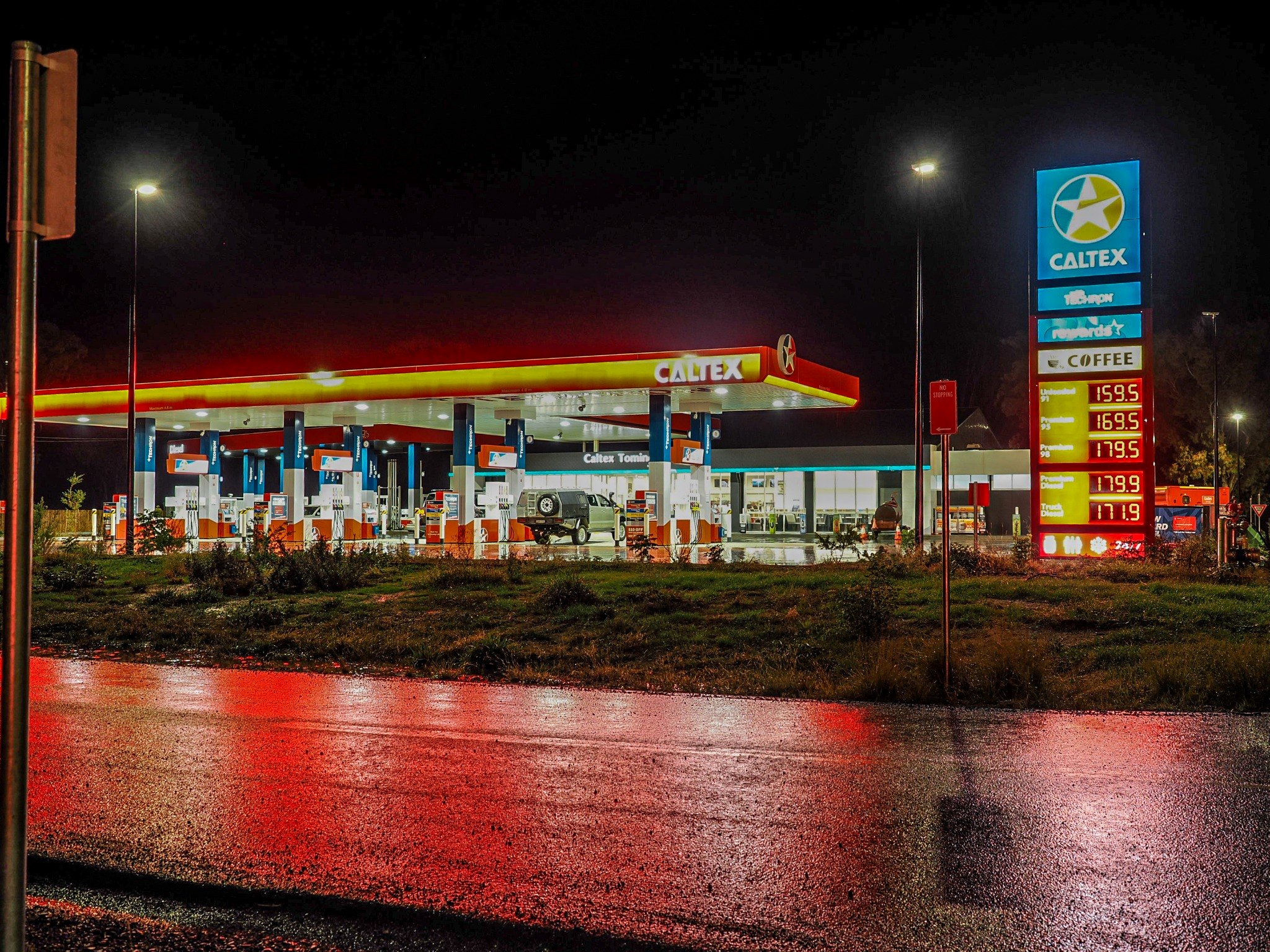 Caltex Tomingley Roadhouse glowing at night after rain